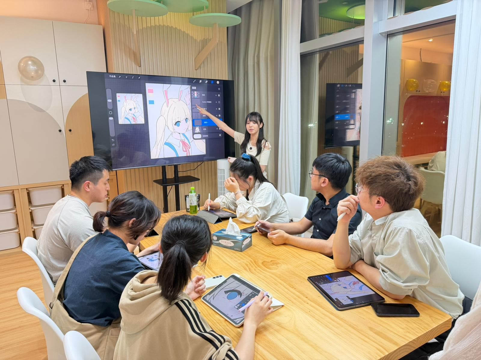 Instructor teaching students Procreate digital art on iPad at Yumewa Academy