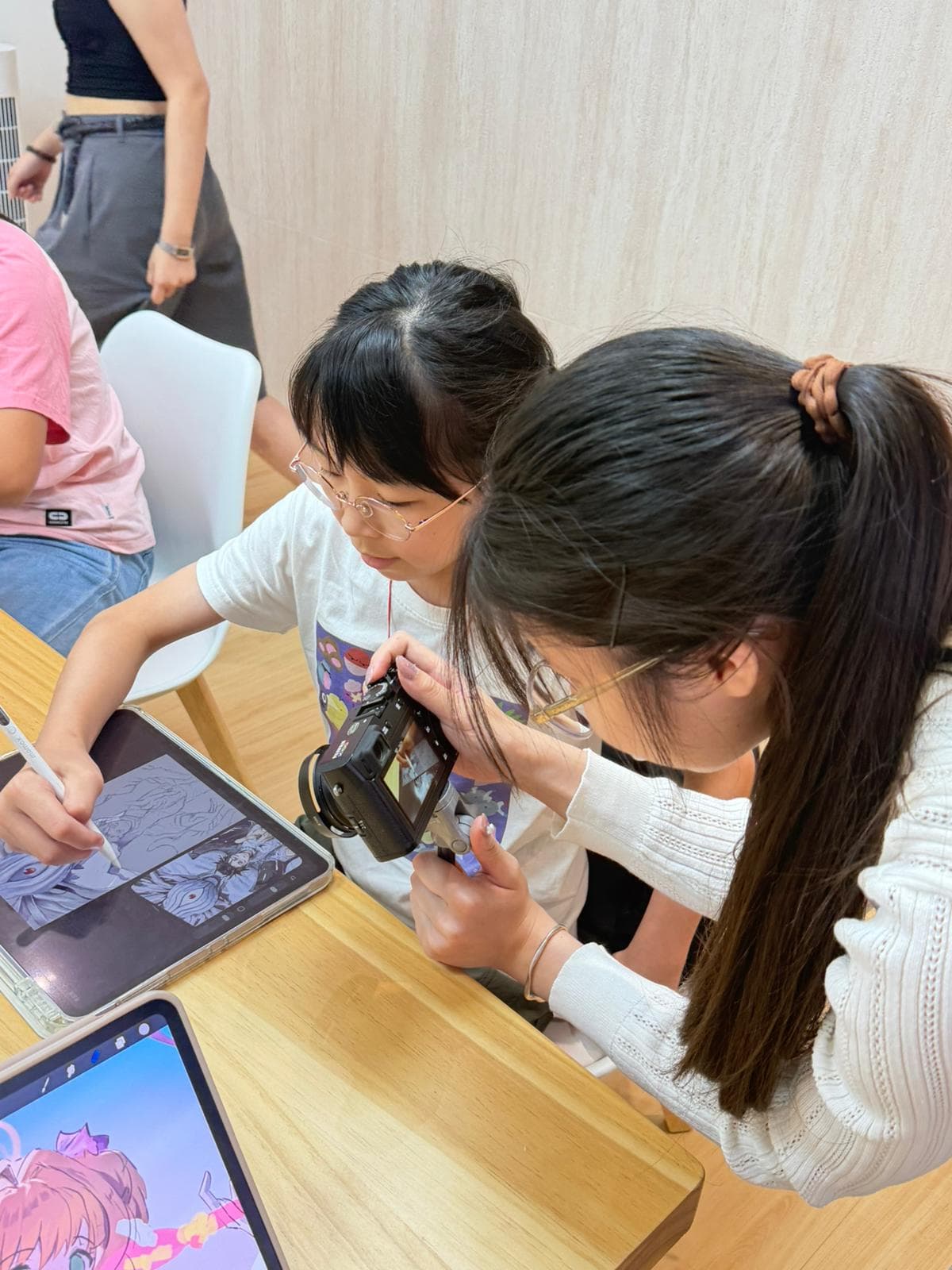 Student creating anime character art with Apple Pencil on iPad